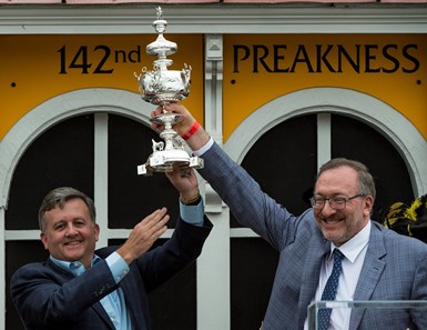 Cloud Computing's co-owners Bill Lawrence, left and Seth Klarman hold the winner's trophy aloft after winning the 142nd running of the Preakness Stakes Saturday May 20, 2017 at Pimlico Race Course in Baltimore, MD