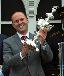 Cloud Computing's trainer holds the winner's trophy aloft after winning the 142nd running of the Preakness Stakes Saturday May 20, 2017 at Pimlico Race Course in Baltimore, MD