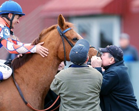 Owner Chris Wilkins gives Wilbo a kiss after his King Cotton Stakes win at Oaklawn Park