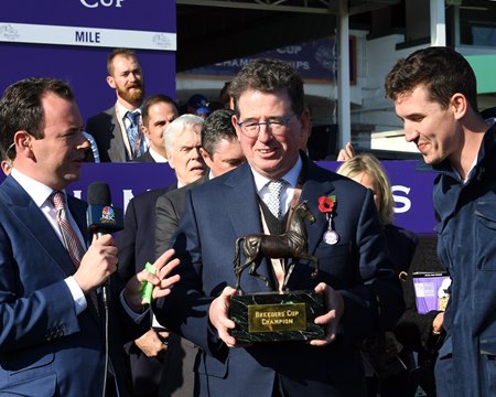 Teddy Grimthorpe holds the Breeders' Cup Mile trophy after Expert Eye's win in 2018 at Churchill Downs