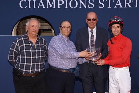 Jaime Mejia (second from left) accepts the trophy after Gladiator King's victory in the 2019 Hutcheson Stakes
