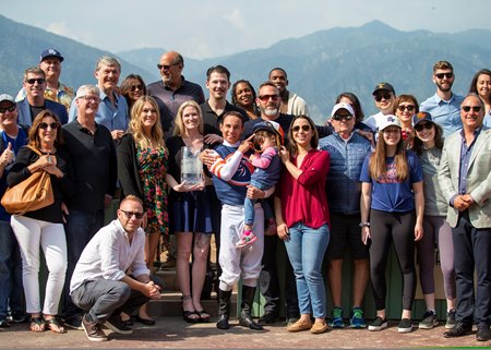 Little Red Feather partners crowd the winner's circle after Marckie's Water's victory in the 2019 Charles Whittingham Stakes at Santa Anita Park