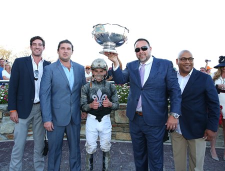 John Fanelli (second from right) holds up the trophy with Saffie Joseph Jr. (second from left) after Math Wizard wins the 2019 Pennsylvania Derby at Parx Racing