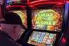 A patron plays a historical horse racing device at Derby City Gaming in Louisville