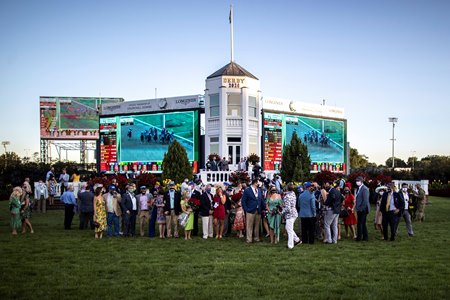Authentic's owners fill the winner's circle after the Kentucky Derby at Churchill Downs