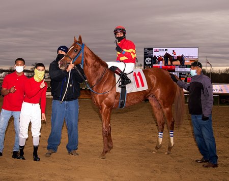 John Hiraldo in the winner's circle aboard Flat Rate at Laurel Park