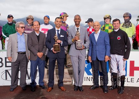 In a joint ceremony this spring jockeys Luis M. Quinones (blue suit/tie) and Deshawn Parker (gray suit) respectively receive the 2020 and 2021 George Woolf Memorial Jockey Awards