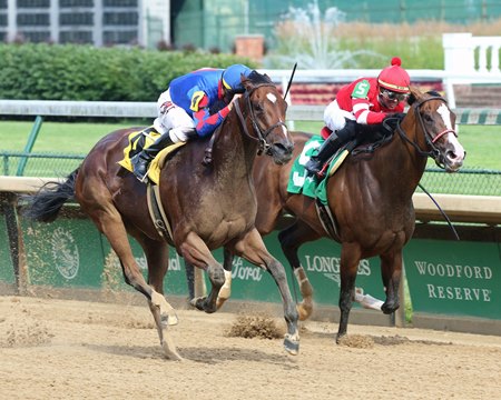 Bell's the One (outside) runs by Sconsin to win the Roxelana Stakes at Churchill Downs