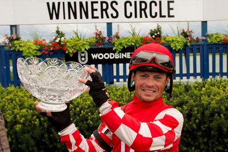 Justin Stein holds the Woodbine Oaks trophy in 2021 at Woodbine