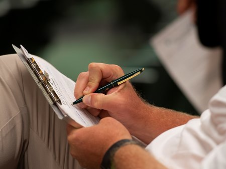 A buyer signs a ticket at the Keeneland September Yearling Sale