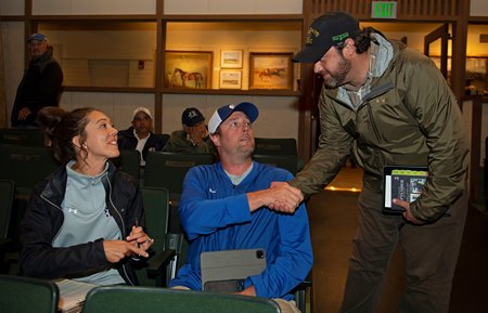 Maddie Mattmiller and Jake Ballis are congratulated by Hill 'n' Dale's Jared Burdine at the Keeneland September Sale