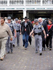 Trainer Chip Woolley is escorted to the post-race press conference after Mine That Bird's 2009 Kentucky Derby victory at Churchill Downs