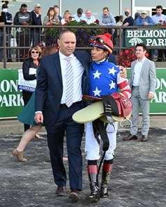 Trainer Chad Brown speaks with jockey Jose Ortiz after Jack Christopher's victory in the Champagne Stakes at Belmont Park