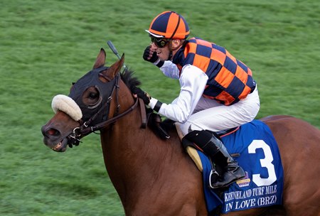 Jockey Alex Achard celebrates a victory from In Love in the 2021 Keeneland Turf Mile at Keeneland