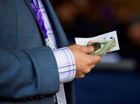 A bettor holds his wagers at the 2021 Breeders' Cup at Del Mar