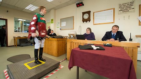 A jockey weighs in before a race