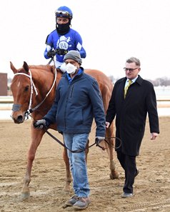 Assistant trainer Toby Sheets (black suit) walks Morello to the winner's circle after his win in the 2022 Gotham Stakes at Aqueduct Racetrack