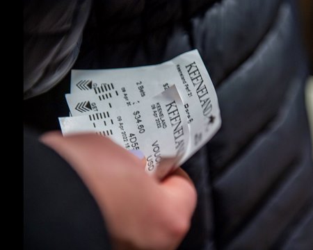 A bettor holds mutuel tickets at Keeneland