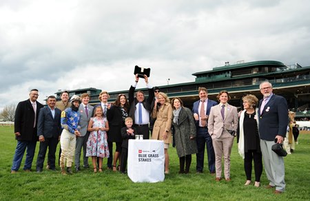 Owner Jeff Drown hoists the Julep Cup after Zandon's victory in the Toyota Blue Grass Stakes at Keeneland