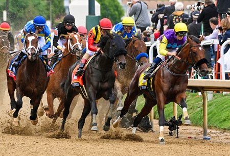 Crown Pride (black hood) chases Summer Is Tomorrow in the early stages of the Kentucky Derby at Churchill Downs