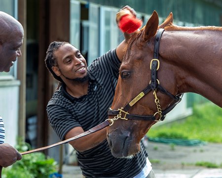 Jerry Dixon Jr. gives 2022 Kentucky Derby winner Rich Strike a bath while his father, Jerry Dixon Sr., keeps a hold