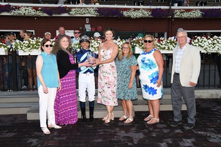 Megan Jones (center) in the trophy presentation for the Galway Stakes after Poppy Flower's victory