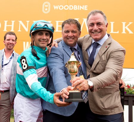 Kevin Attard (middle) celebrates Moira's 2022 Queen's Plate victory with jockey Rafael Hernandez and X-Men Racing's Donato Lanni at Woodbine