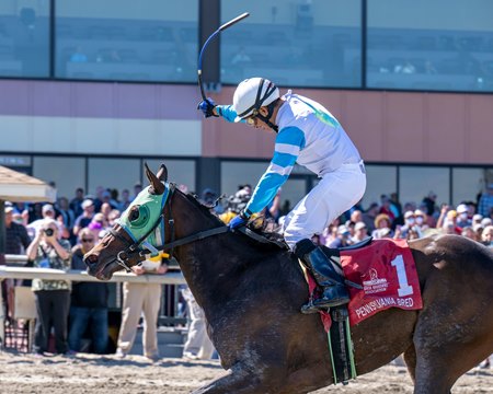 Jockey David Cora celebrates a victory from Midnight Parade in the Imply Stakes at Parx Racing