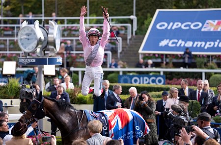 Dettori makes his trademark flying dismount from Emily Upjohn after winning the Fillies & Mares Stakes at Ascot Racecourse