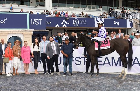Patrick Lewis (third from right) and Bo Bromagen (second from right) in the winner's circle after Red Carpet Ready's victory in the Forward Gal Stakes at Gulfstream Park
