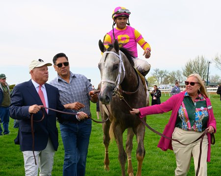 Owners Antony Beck (left) and Mandy Pope (right) lead Tapit Trice to the winner's circle after his victory in the Blue Grass Stakes at Keeneland
