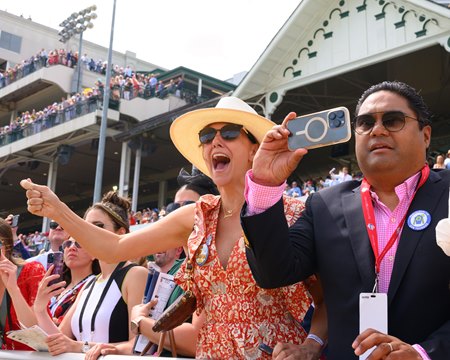 Fans cheer during a race at Churchill Downs