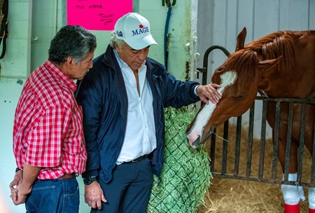 Mage in his stall at Churchill Downs May 7 with groom Moises Morales (L) and trainer Gustavo Delgado Sr.