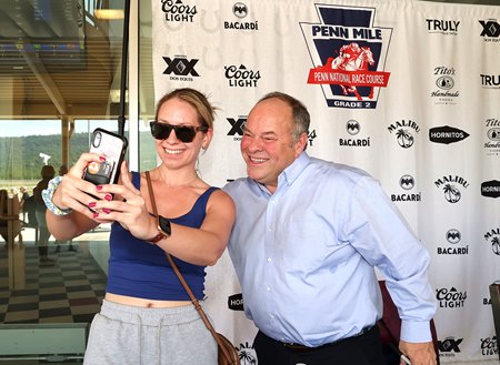 Track announcer Larry Collmus greets fans at Penn National Race Course