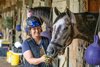 Trainer Melanie Giddings spends some quality time with her stakes winning filly Maple Leaf Mel in her barn at the Oklahoma Training Center adjacent to the Saratoga Race Course July 12, 2023 in Saratoga Springs, N.Y..  Photo by Skip Dickstein
