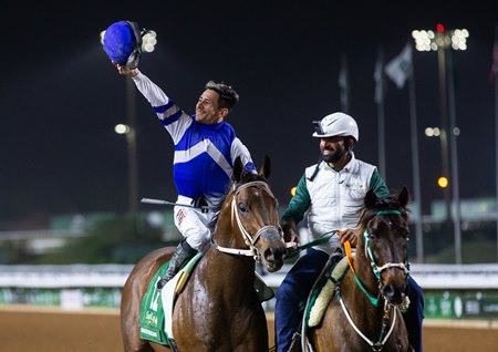 Junior Alvarado raises his helmet in triumph after a victory from Senor Buscador in the Saudi Cup at King Abdulaziz Racecourse