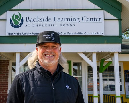 Sierra Leone co-owner Brook Smith in front of the Backside Learning Center at Churchill Downs
