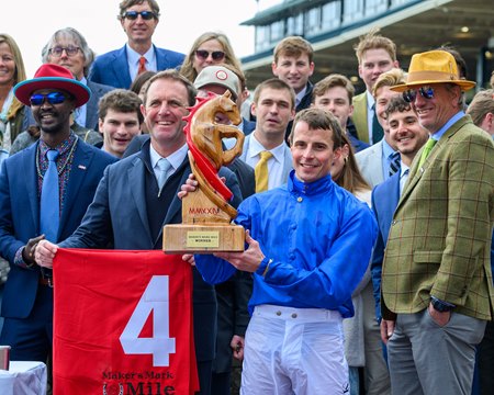 (L-R): Trainer Charlie Appleby (holding saddle towel), jockey William Buick, and others celebrate a victory from Master of The Seas in the Maker's Mark Mile Stakes at Keeneland