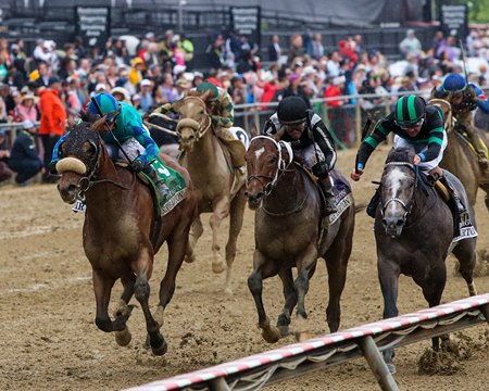 Corporate Power (outside) wins a three-horse photo finish in the Sir Barton Stakes at Pimlico Race Course