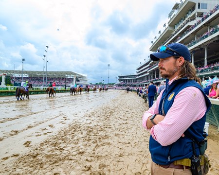 Kentucky Horse Racing Commission chief veterinarian Dr. Nick Smith watches horses in the post parade May 3 at Churchill Downs