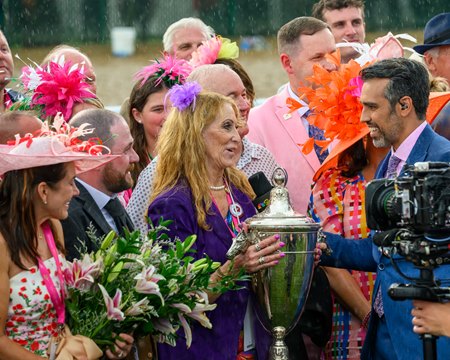 Breeder and co-owner Judy Hicks holds the Kentucky Oaks trophy after Thorpedo Anna's victory this year at Churchill Downs