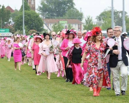 Cancer survivors and their loved ones participate in the Survivors Parade at Churchill Downs