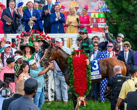 Mystik Dan wears the garland of roses in the Kentucky Derby winner's circle at Churchill Downs