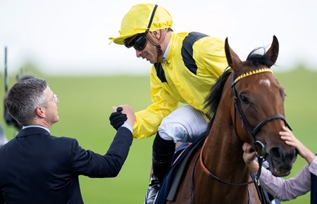 Silvestre de Sousa and Roger Varian greet each other after Elmalka's win in the One Thousand Guineas at Newmarket
