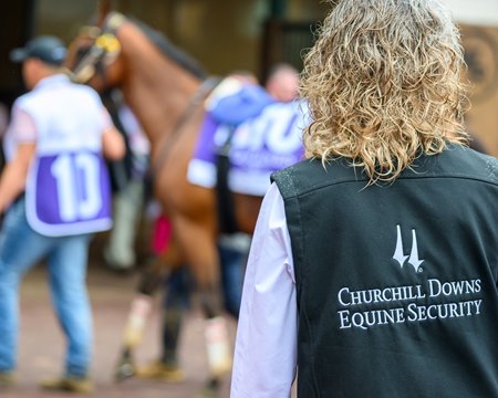 A member of the Churchill Downs equine security team monitors a horse at Churchill Downs