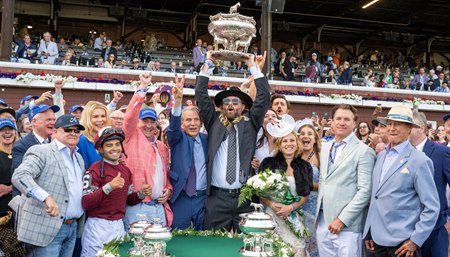 With Randy Hill to the left, Jayson Werth hoists the Belmont Stakes trophy after Dornoch's victory in the Belmont Stakes at Saratoga Race Course