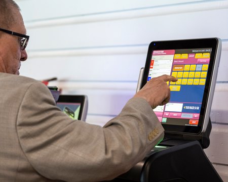 A bettor wagers on a touch screen terminal