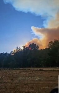  A wildfire burns in the distance near Ruidoso, N.M.