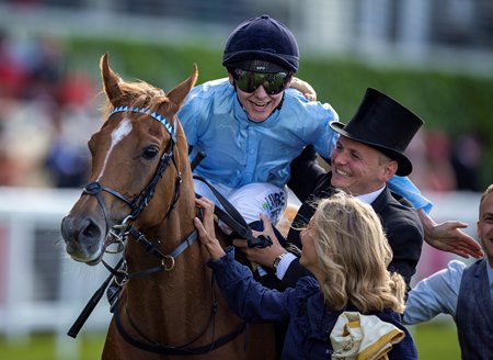 Rider Billy Loughnane is congratulated by trainer George Boughey after Soprano's win in a handicap at Ascot Racecourse