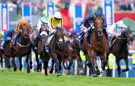 City of Troy (navy silks) wins the Epsom Derby at Epsom Racecourse